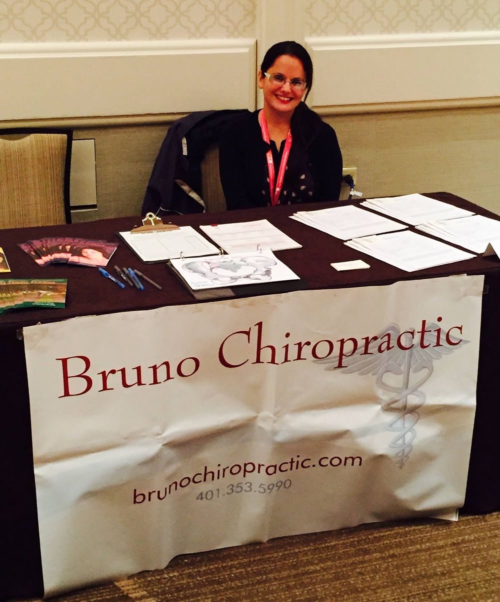 Dr. Erika Bruno at a Bruno Chiropractic table during a community health event